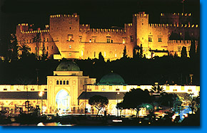 Night view of Mandraki and the medieval castle of Rhodes.